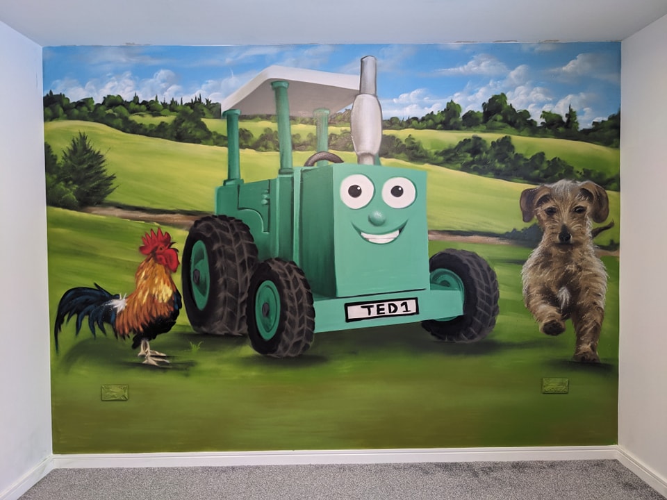 A vibrant children bedroom wall mural depicting a smiling green cartoon tractor Tom, a realistic rooster, and a running wire-haired terrier in a green, rolling countryside setting.